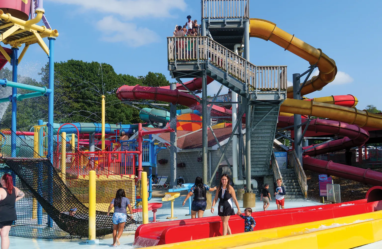 Lanscape shot of Water Park, showing people walking around, showing various water slides