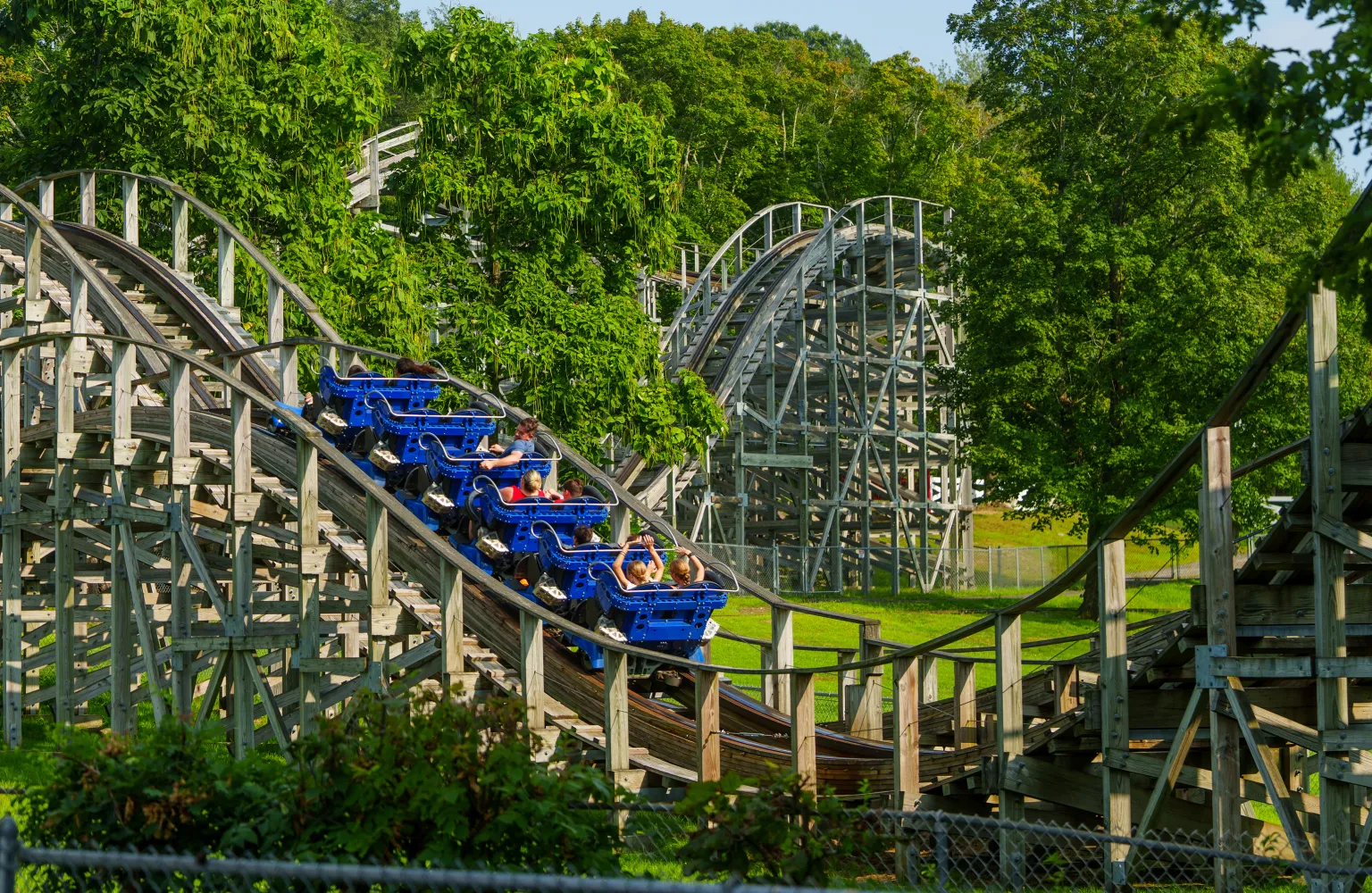 Landscape shot showing people on Wooden Warrior roller coaster