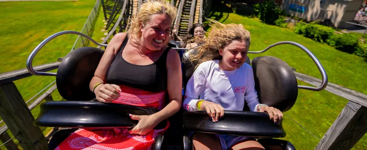 Adult and child on Wooden Warrior roller coaster