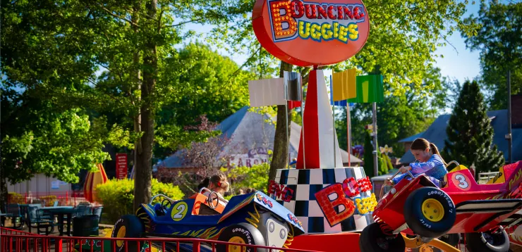 Bouncing Buggies ride, with light up sign and children in ride cars