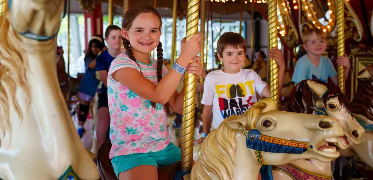 Smiling girl and boy on Grand Carousel ride