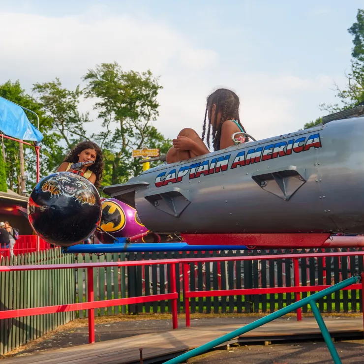 Two children on Jet Fighters ride